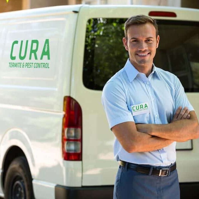 Cura employee standing beside Cura truck with hands crossed